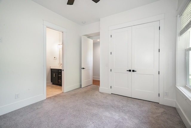 unfurnished bedroom with ceiling fan, light colored carpet, and multiple windows