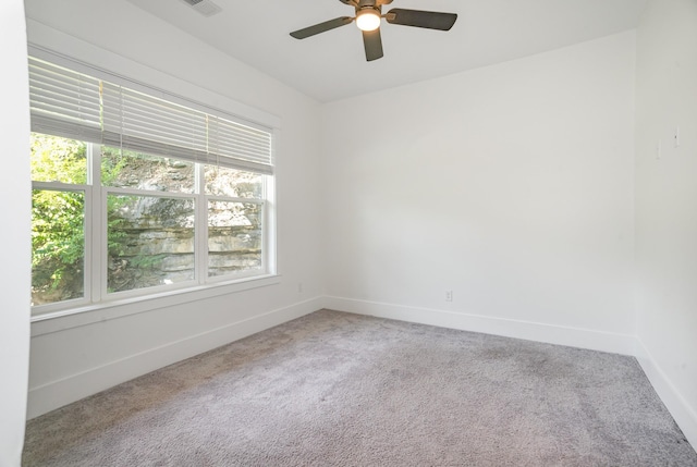 carpeted empty room featuring ceiling fan