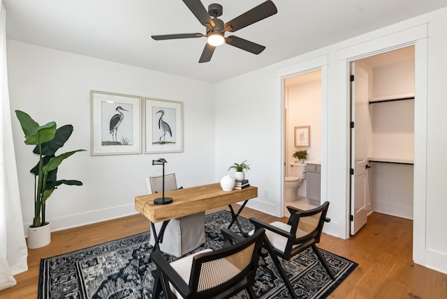 office with ceiling fan and light hardwood / wood-style floors