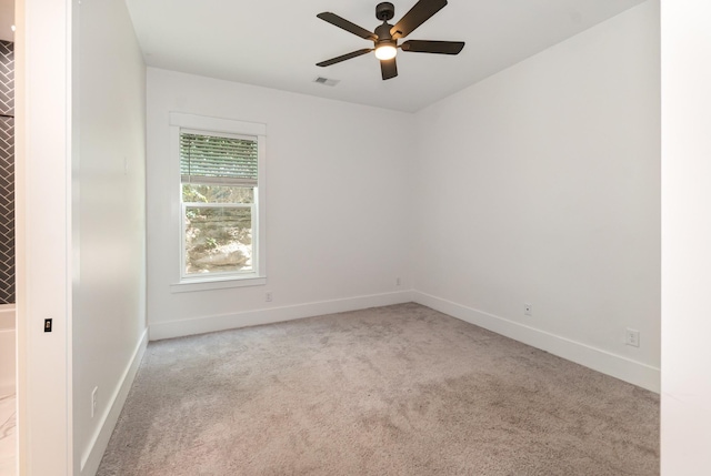 unfurnished room featuring light carpet and ceiling fan