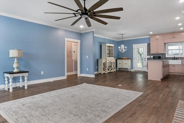 interior space with ceiling fan with notable chandelier, dark hardwood / wood-style floors, and crown molding