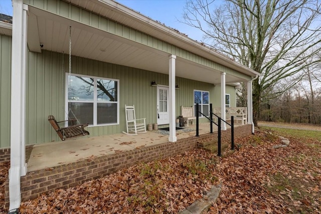 view of exterior entry featuring a porch