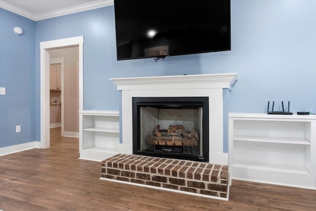 details featuring hardwood / wood-style flooring, a brick fireplace, and crown molding