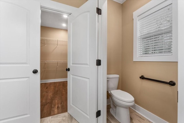 bathroom with hardwood / wood-style floors and toilet