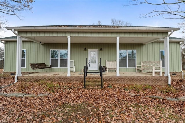 back of property with a porch