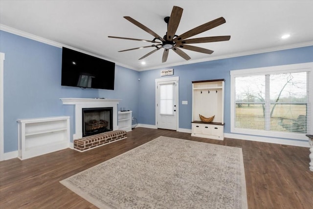 unfurnished living room with a fireplace, dark hardwood / wood-style flooring, and ornamental molding