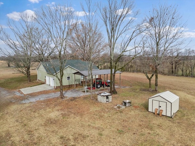 view of yard featuring a patio area and a storage shed