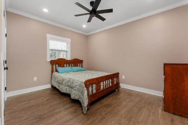 bedroom featuring ceiling fan, ornamental molding, and hardwood / wood-style flooring