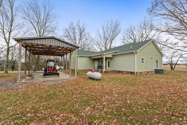 exterior space featuring central air condition unit and a carport