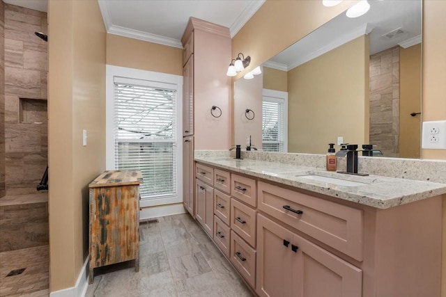 bathroom featuring vanity, crown molding, and a healthy amount of sunlight