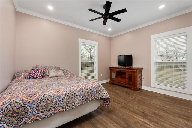 bedroom featuring multiple windows, ceiling fan, crown molding, and dark wood-type flooring