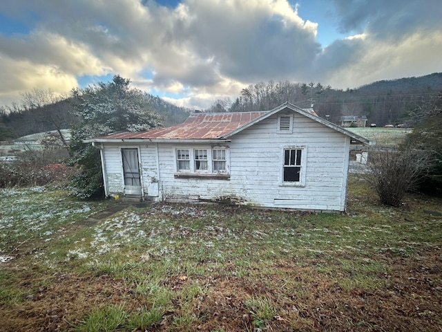 rear view of property with a yard