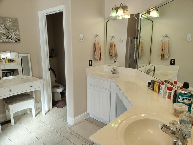 bathroom featuring tile patterned floors, vanity, and toilet