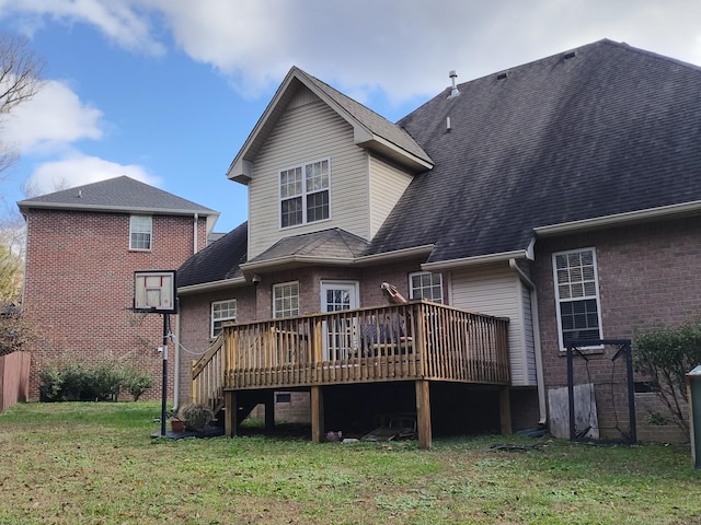 back of property featuring a deck and a yard