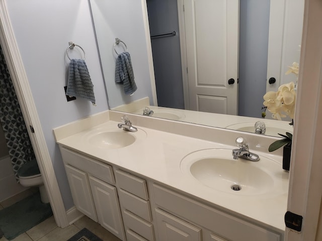 bathroom with tile patterned floors, vanity, curtained shower, and toilet