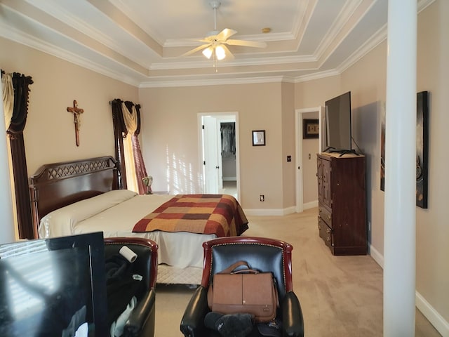 carpeted bedroom featuring a tray ceiling, ceiling fan, and crown molding