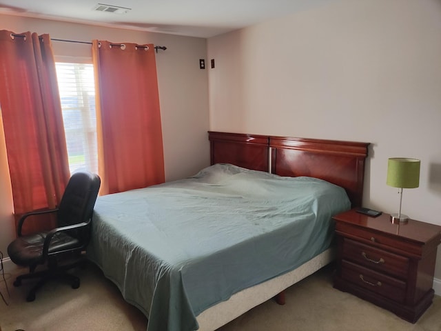 bedroom featuring light carpet