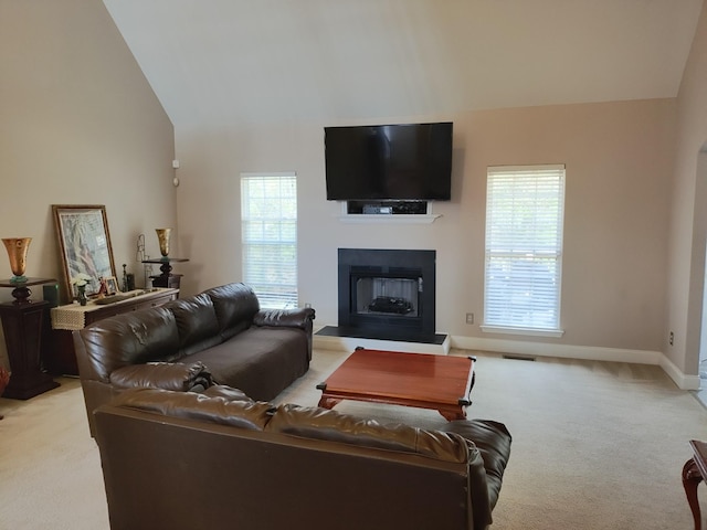 carpeted living room with lofted ceiling