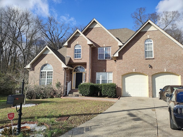 view of front property with a garage and a front lawn