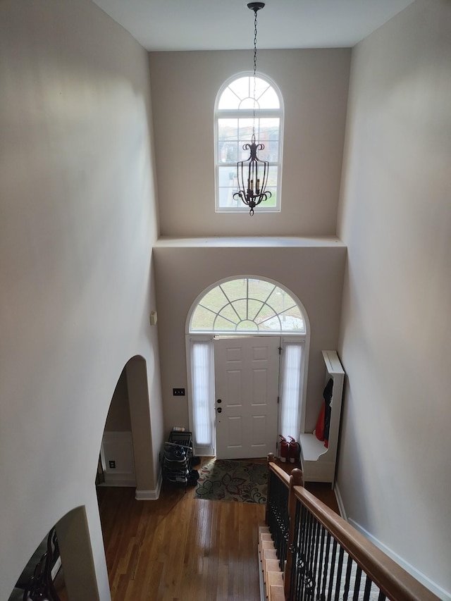 entrance foyer with dark wood-type flooring and a notable chandelier