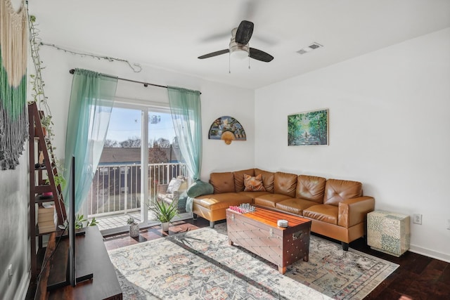 living room featuring ceiling fan and dark hardwood / wood-style flooring