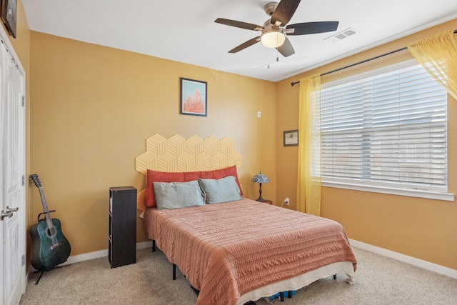 carpeted bedroom featuring ceiling fan and a closet