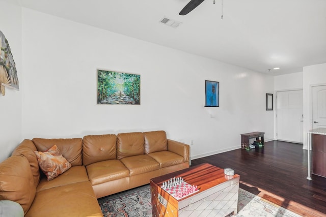 living room with ceiling fan and dark hardwood / wood-style flooring