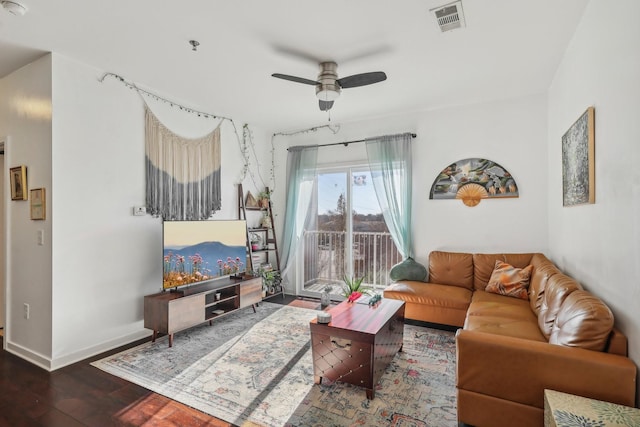 living room featuring ceiling fan and dark hardwood / wood-style flooring