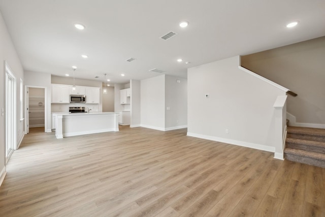 unfurnished living room with light hardwood / wood-style floors