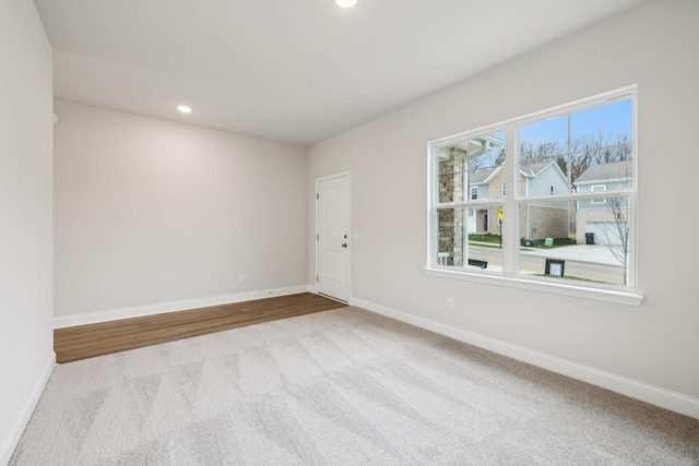 unfurnished room with light colored carpet