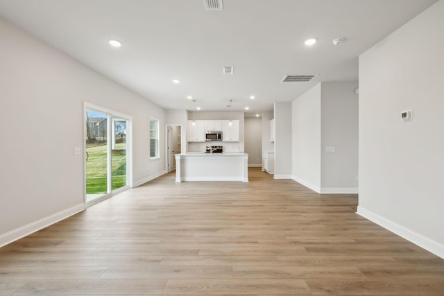 unfurnished living room with light hardwood / wood-style flooring