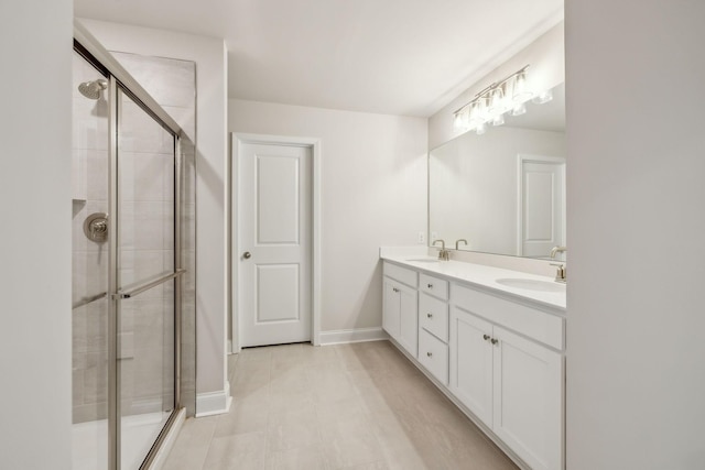 bathroom featuring vanity and a shower with shower door