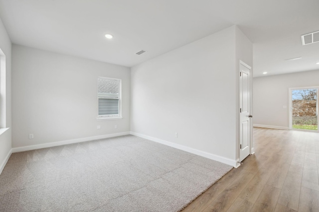 empty room with light hardwood / wood-style floors