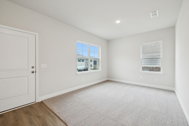 spare room with wood-type flooring