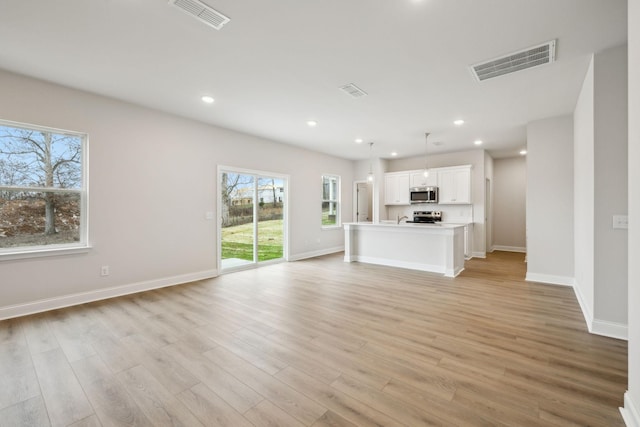 unfurnished living room featuring light hardwood / wood-style flooring