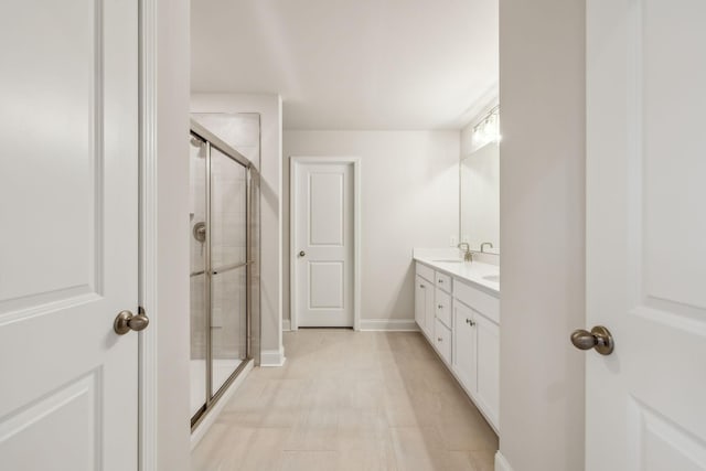 bathroom featuring vanity and an enclosed shower