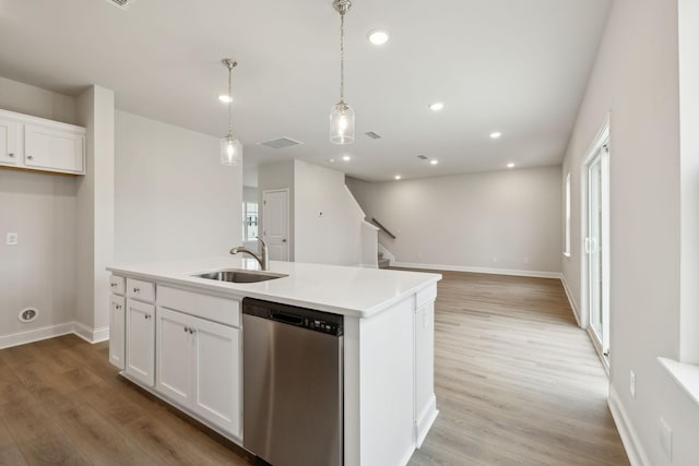 kitchen featuring dishwasher, a center island with sink, white cabinetry, and sink