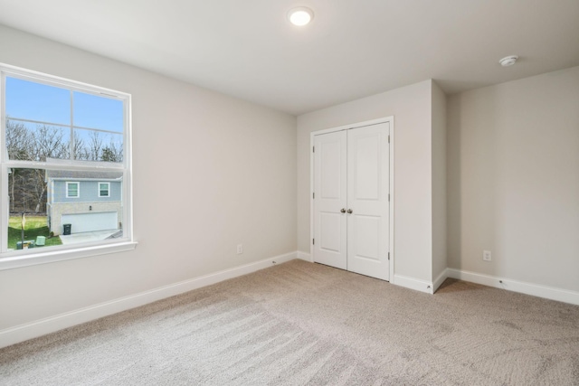 unfurnished bedroom with a closet and carpet