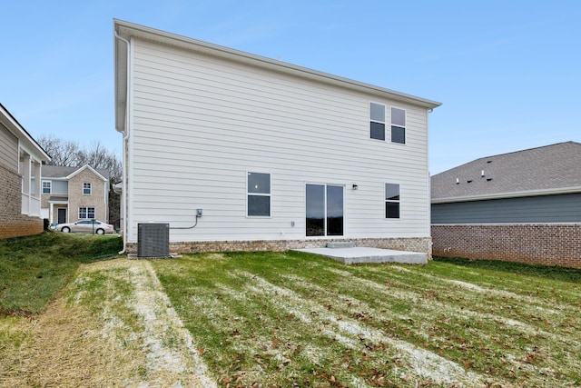 rear view of house with a lawn and central AC