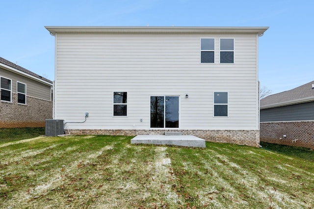 back of property featuring a lawn, cooling unit, and a patio