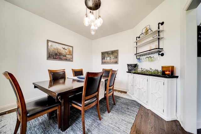 dining area featuring a chandelier and dark hardwood / wood-style floors