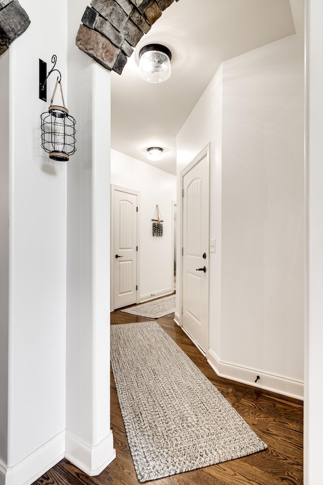 hallway featuring dark hardwood / wood-style flooring