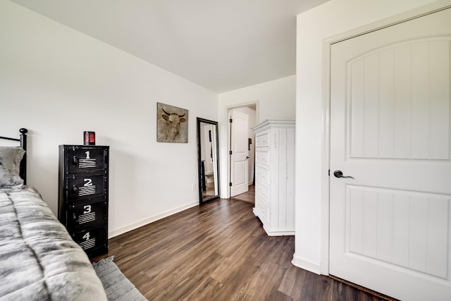 bedroom with dark wood-type flooring