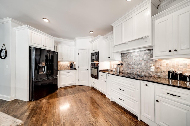 kitchen featuring black appliances, dark hardwood / wood-style flooring, white cabinets, and dark stone counters