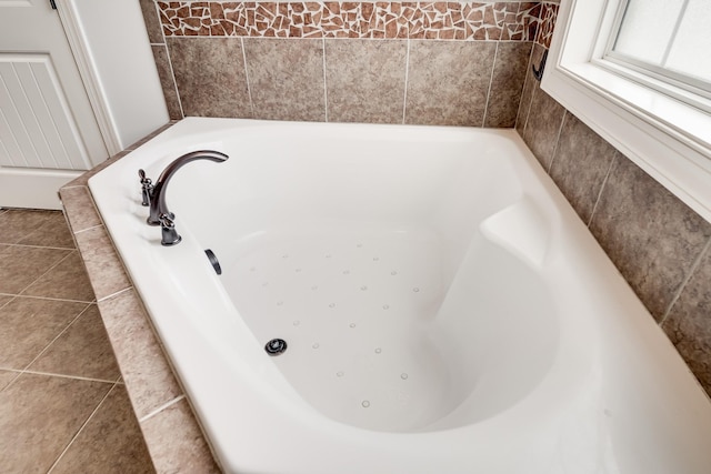 bathroom with a tub and tile patterned flooring