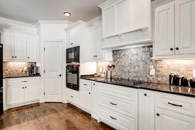 kitchen with white cabinets, dark hardwood / wood-style floors, ornamental molding, and tasteful backsplash