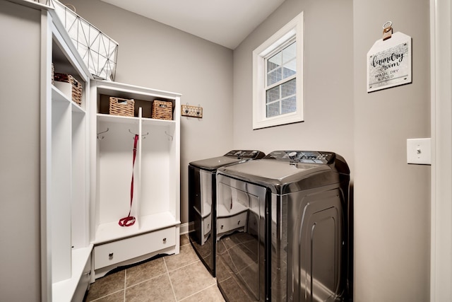 laundry room featuring independent washer and dryer and light tile patterned floors