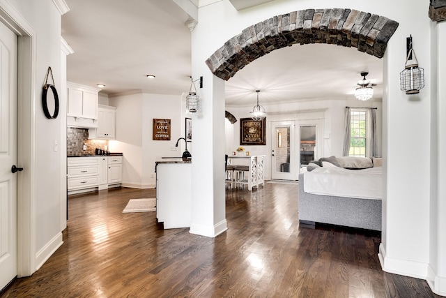 interior space with sink, dark hardwood / wood-style flooring, and crown molding