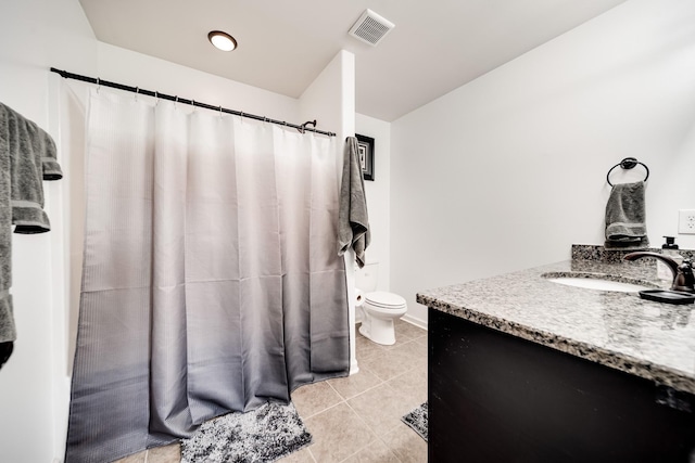 bathroom with tile patterned floors, vanity, and toilet