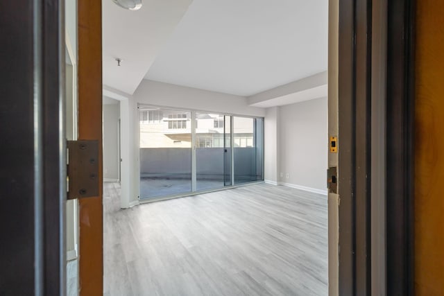 empty room with light hardwood / wood-style floors